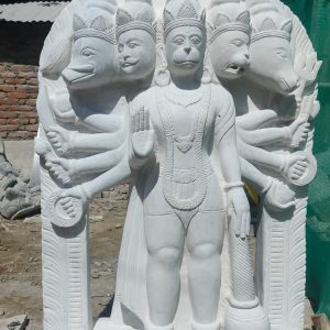 This magnificent Panchamukhi Hanuman Murti is handcrafted by experienced Nepali artisans using high-quality natural marble and traditional carving techniques. The five faces of Lord Hanuman symbolize different divine energies: Hanuman – Strength, devotion, and courage Narasimha – Protection from evil and fear Garuda – Freedom from negativity and harmful influences Varaha – Prosperity, stability, and protection of the Earth Hayagriva – Knowledge, wisdom, and intelligence Intricately carved with exceptional attention to detail, this sacred sculpture reflects Nepal's rich artistic heritage. It is a powerful symbol of faith, protection, and spiritual strength, making it an ideal centerpiece for temples, homes, and meditation spaces. Features Handmade by skilled Nepali artisans Crafted from premium-quality natural marble Traditional Nepali stone carving with intricate detailing Depicts the sacred five-faced form of Lord Hanuman Symbolizes protection, courage, wisdom, prosperity, and devotion Ideal for temples, home shrines, meditation rooms, and spiritual centers Weather-resistant and suitable for both indoor and outdoor installation Specifications Material: Natural Marble Origin: Nepal Finish: Hand-Carved White Marble Style: Traditional Nepali Religious Sculpture Usage: Worship, Temple Decoration, Home Decoration, Meditation Space, Garden Décor, Gift Item Bring the divine blessings of Panchamukhi Hanuman into your home or temple with this beautifully handcrafted marble murti. A timeless symbol of strength, protection, wisdom, and unwavering devotion, it showcases the exceptional craftsmanship of Nepalese artisans and serves as a sacred addition to any spiritual space.